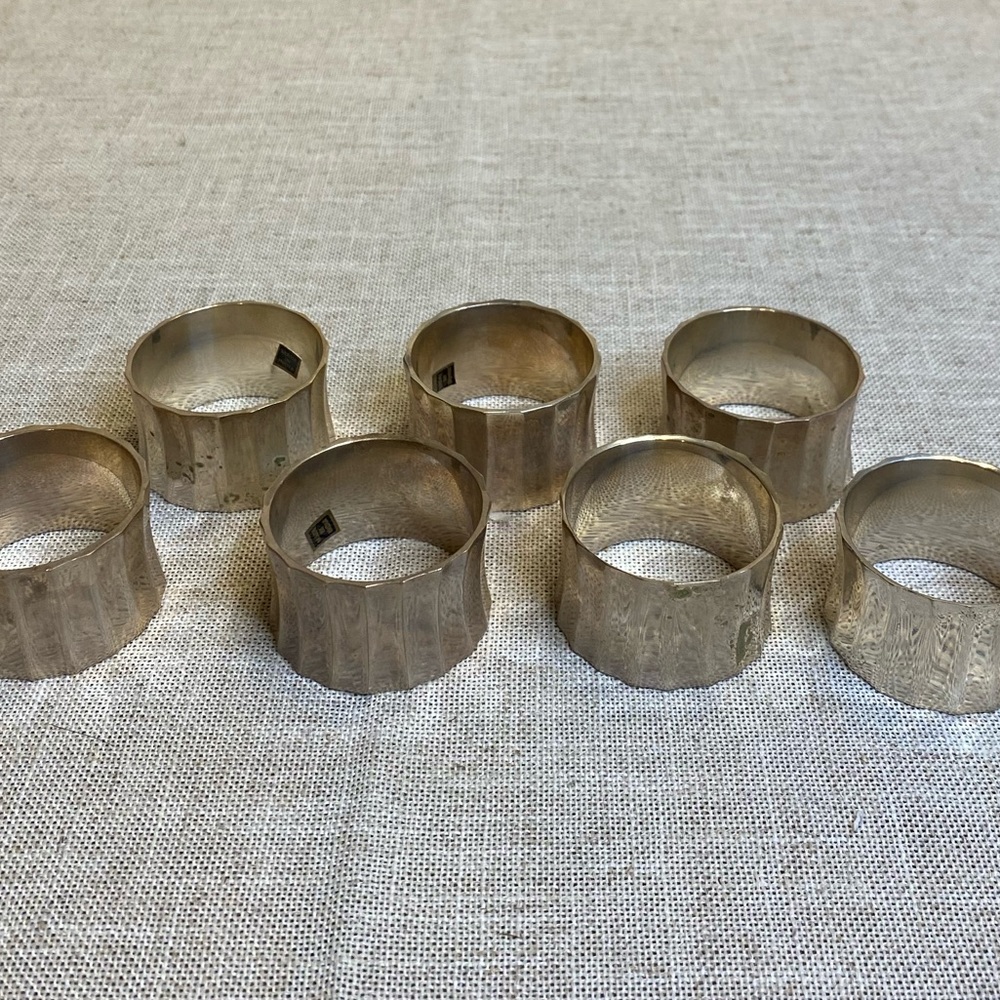 7 silver napkin holder rings made in India. Some tarnish.